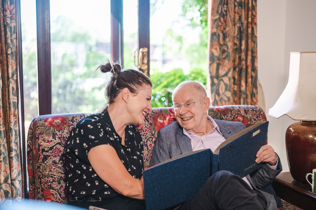 Woman reading to older man